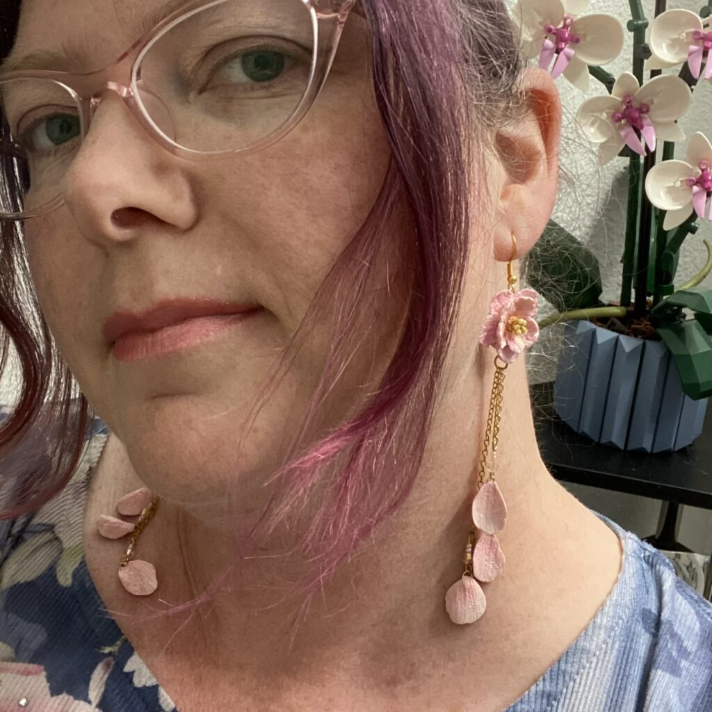 Photo of Kristi Anderson wearing handmade blossom earrings.